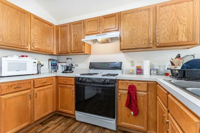a kitchen with stainless steel appliances granite countertop a sink and cabinets