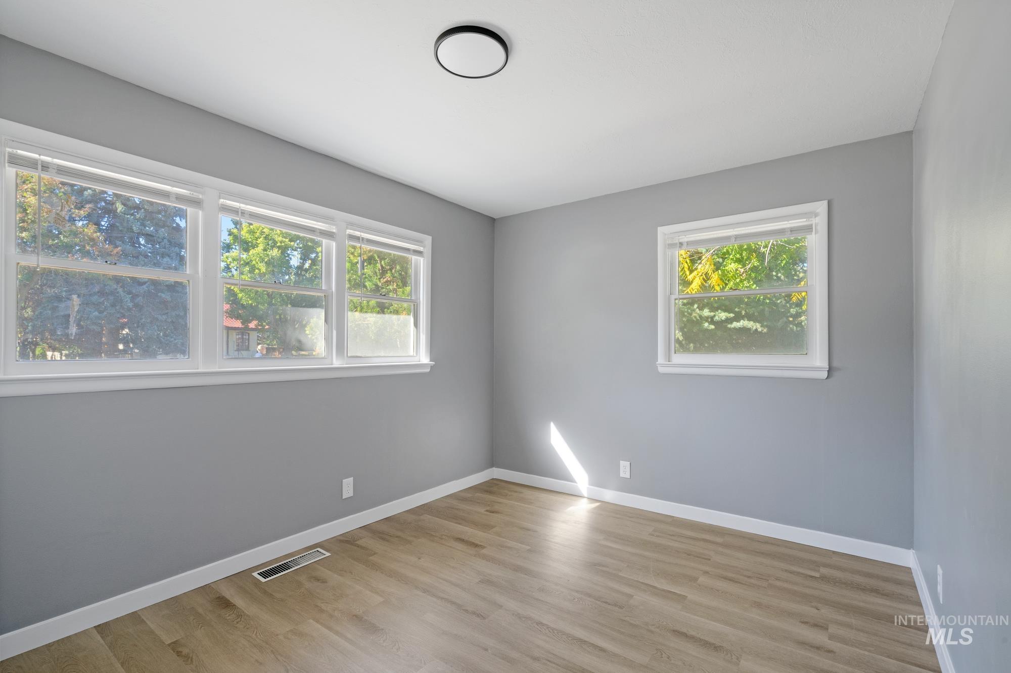 716 West Linden Street Boise, ID 83706 - Photo 16 of 47 Unfurnished room with baseboards and light wood-type flooring