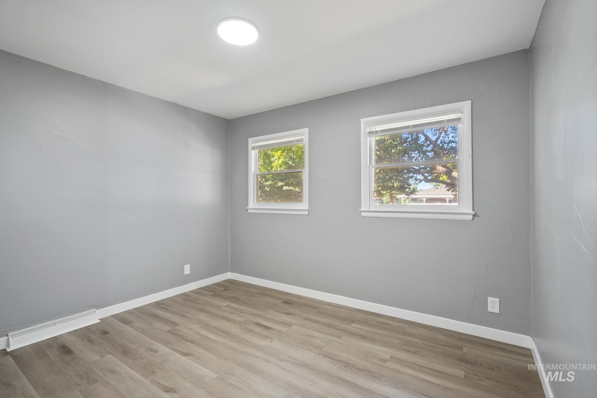 716 West Linden Street Boise, ID 83706 - Photo 18 of 47 Spare room with baseboards and light wood-style flooring