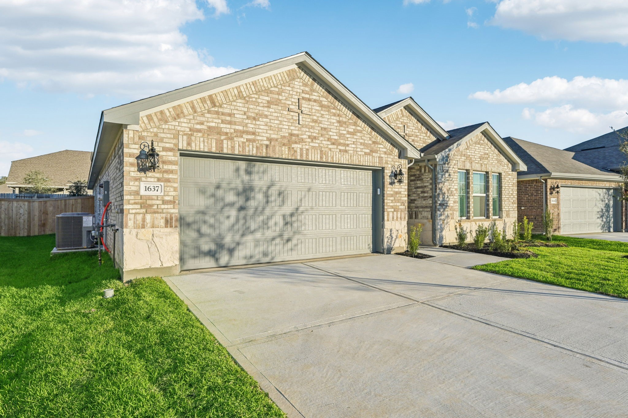 1637 Hopson Ranch Drive Conroe, TX 77301 - Photo 2 of 39 a front view of a house with garden