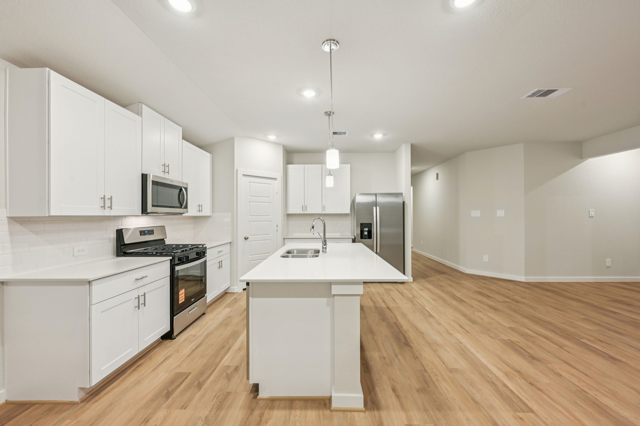 1637 Hopson Ranch Drive Conroe, TX 77301 - Photo 10 of 39 a room with kitchen island a sink stainless steel appliances and cabinets