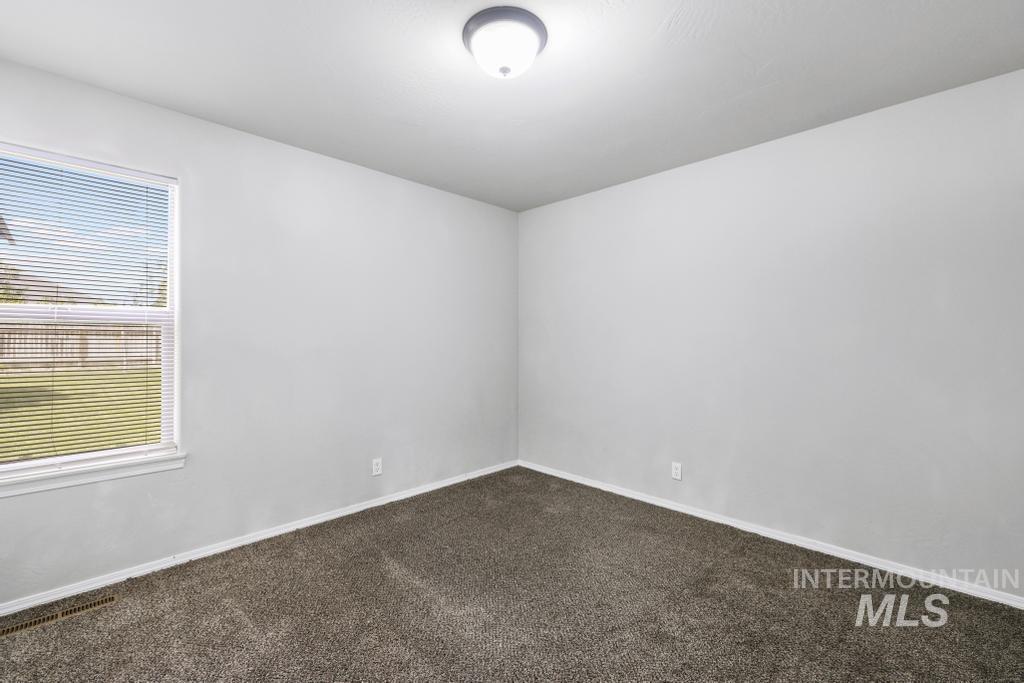 1183 Cortes Loop Twin Falls, ID 83301 - Photo 15 of 30 Neutral interior room featuring light gray walls, plush gray carpet, and white baseboards