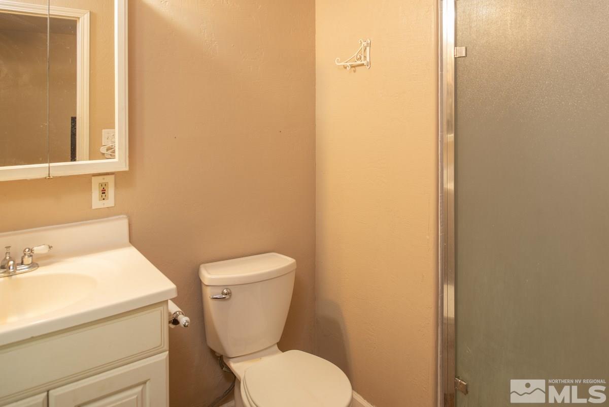 105 Bisby Street Reno, NV 89512 - Photo 16 of 17 a white toilet sitting next to a bathroom sink