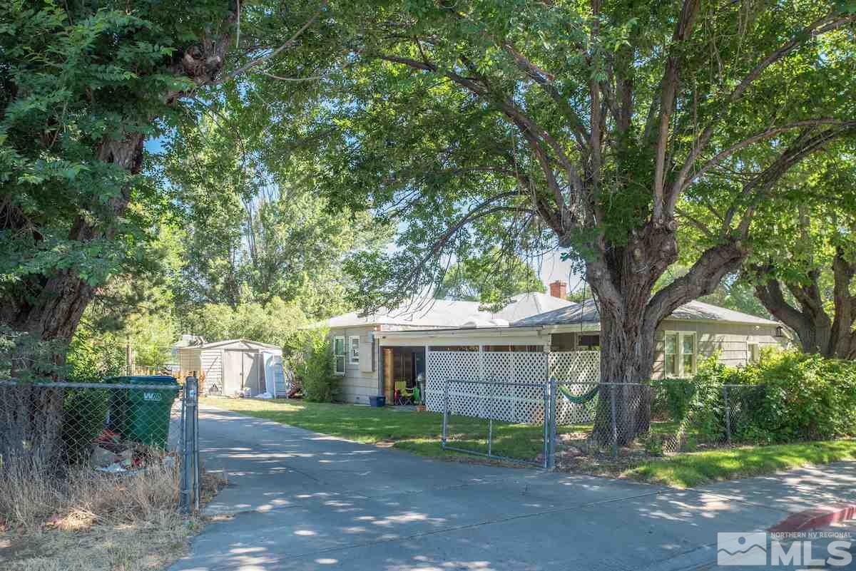 105 Bisby Street Reno, NV 89512 - Photo 4 of 17 a view of a yard in front of a house with large tree