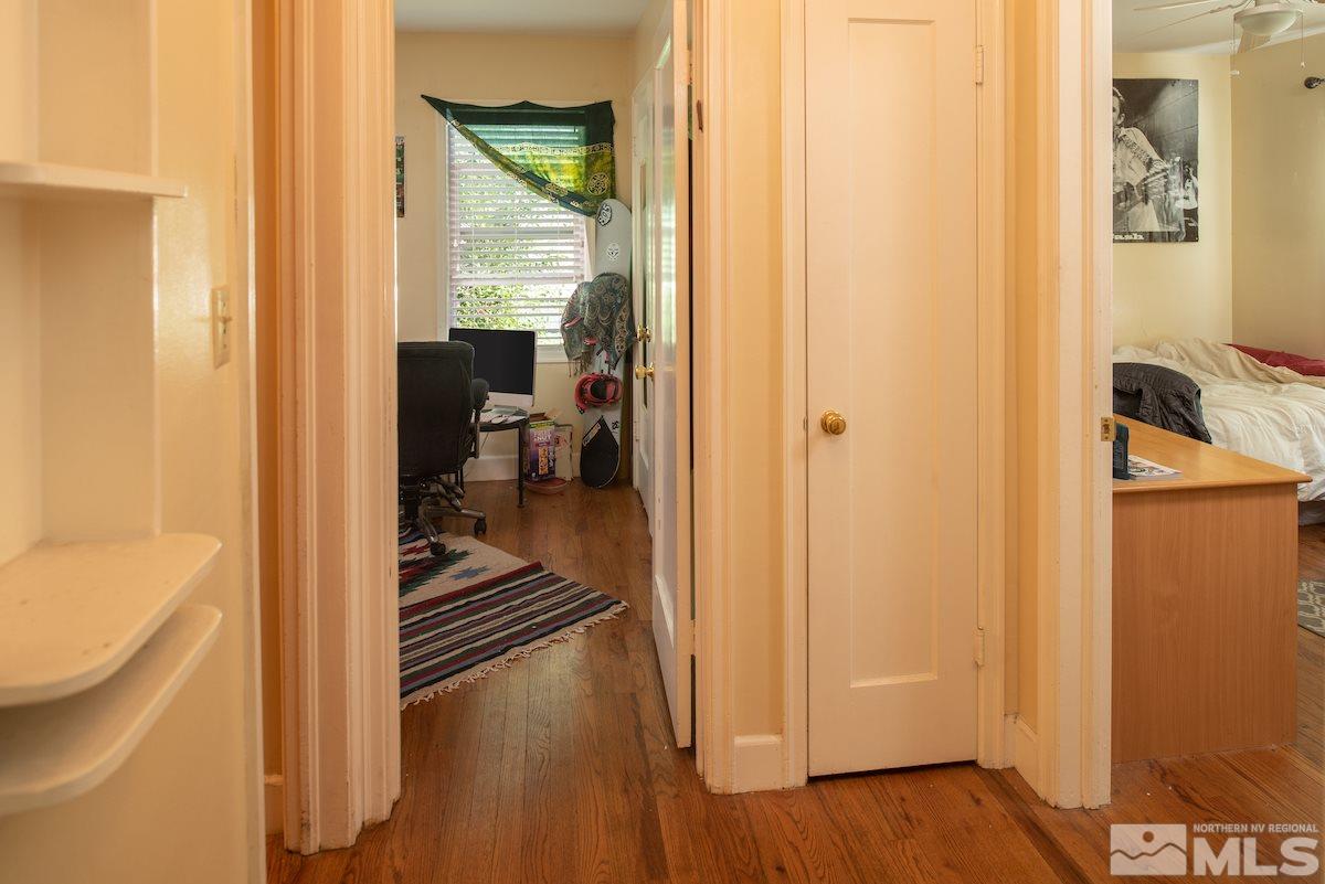 105 Bisby Street Reno, NV 89512 - Photo 9 of 17 a hallway with wooden floor windows and a bathroom