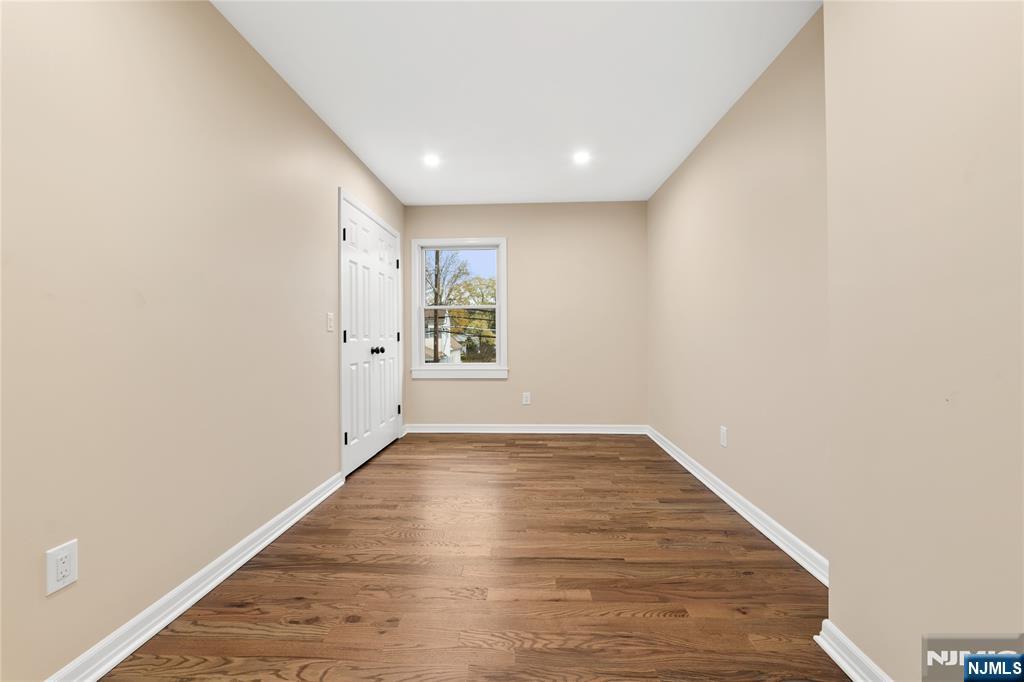 937 Ringwood Avenue, Unit 2 Wanaque, NJ 07420 - Photo 6 of 11 an empty room with wooden floor and windows