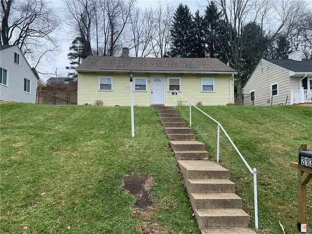 a front view of house with yard and green space