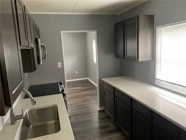 a kitchen with a sink and a refrigerator
