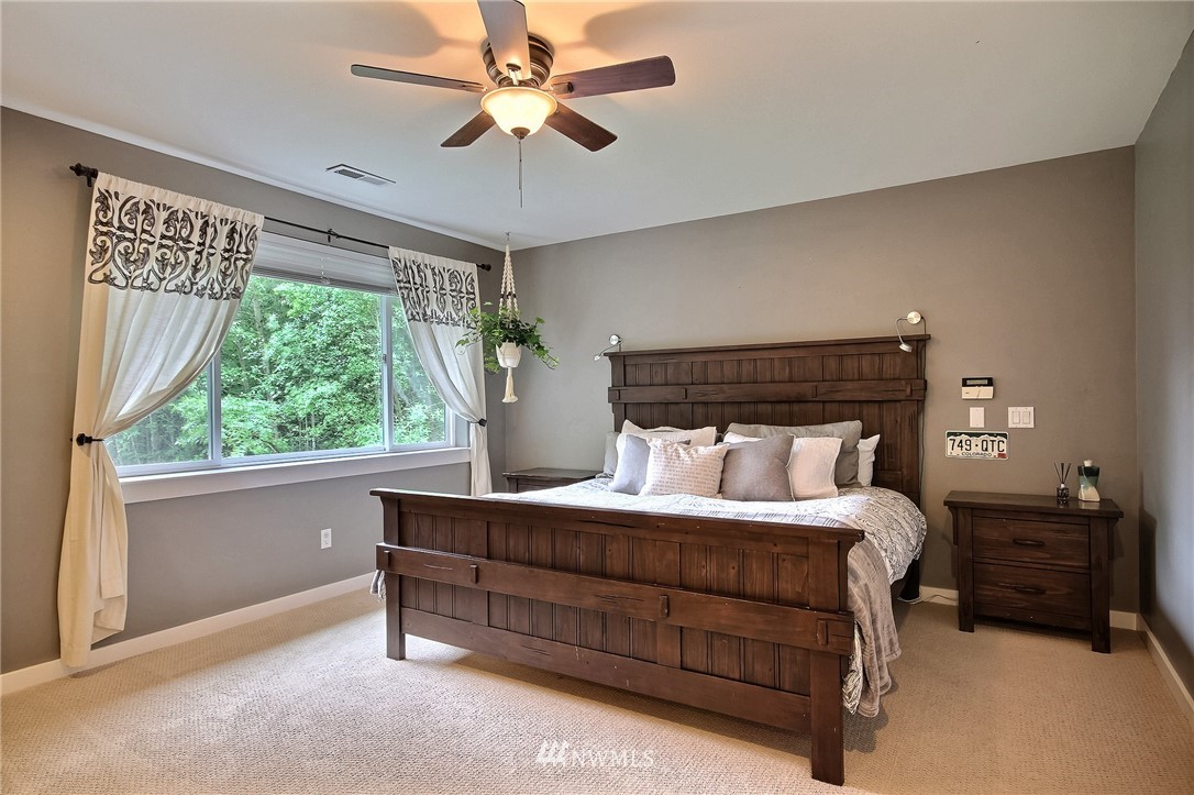 4706 224th Street Southeast Bothell, WA 98021 - Photo 14 of 38 a bedroom with a large bed and a window