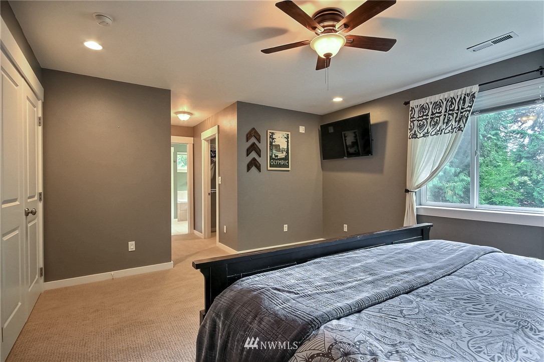 4706 224th Street Southeast Bothell, WA 98021 - Photo 15 of 38 a bedroom with a large bed and a window