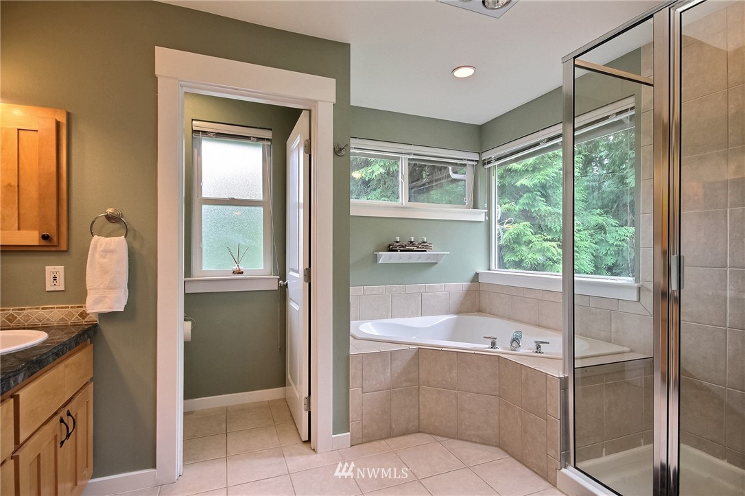 4706 224th Street Southeast Bothell, WA 98021 - Photo 18 of 38 a bathroom with a tub sink and mirror