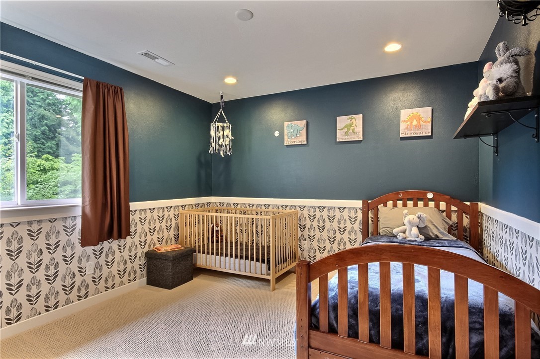 4706 224th Street Southeast Bothell, WA 98021 - Photo 19 of 38 a bedroom with furniture and a window