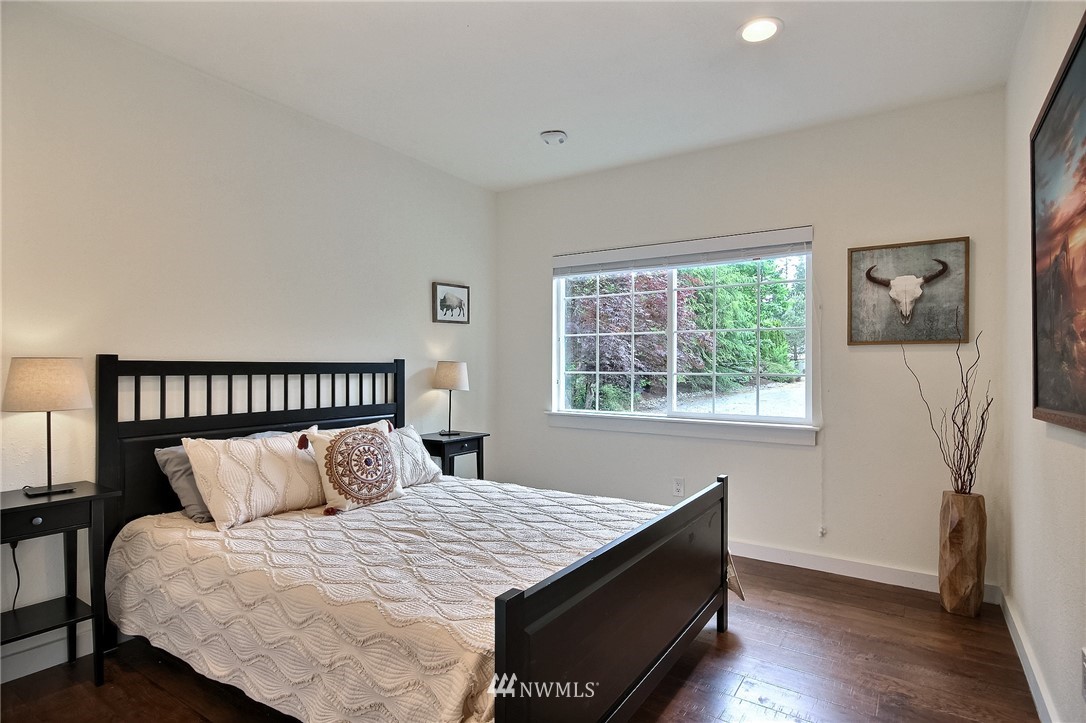 4706 224th Street Southeast Bothell, WA 98021 - Photo 22 of 38 a bed sitting in a bedroom next to a window