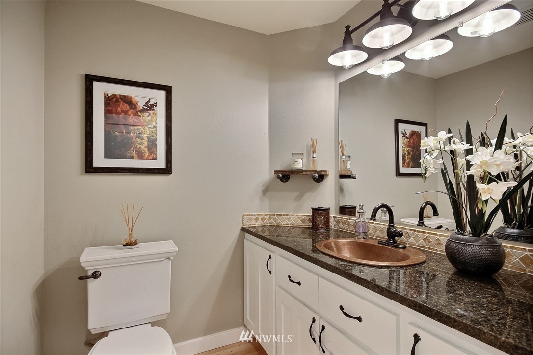 4706 224th Street Southeast Bothell, WA 98021 - Photo 24 of 38 a bathroom with a toilet a sink and mirror