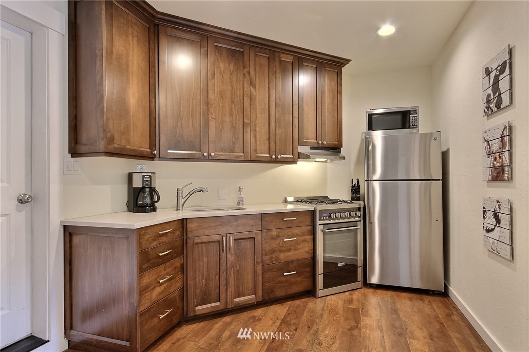 4706 224th Street Southeast Bothell, WA 98021 - Photo 30 of 38 a kitchen with stainless steel appliances granite countertop a refrigerator and a stove top oven