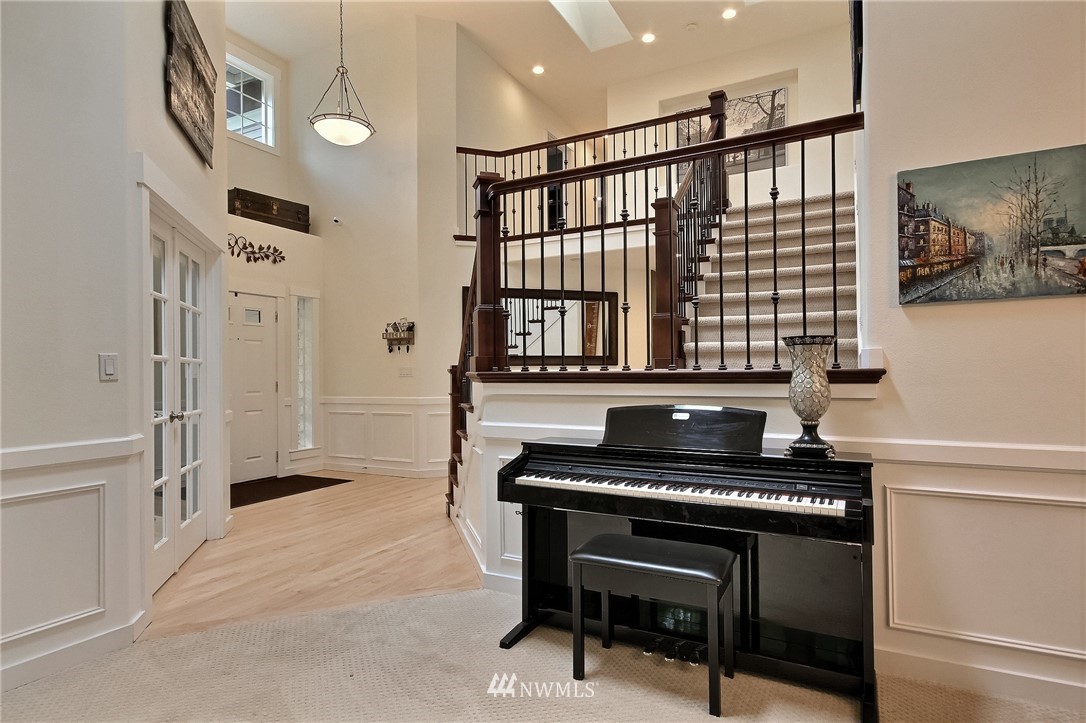 4706 224th Street Southeast Bothell, WA 98021 - Photo 5 of 38 a hallway with a piano a rug and a window