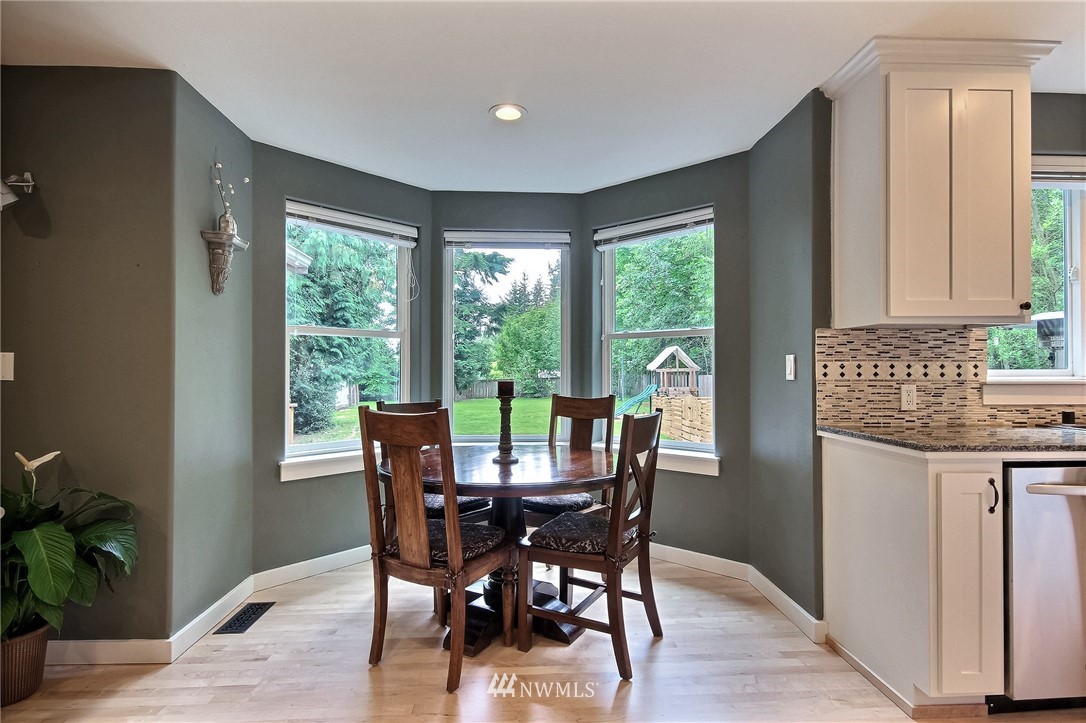 4706 224th Street Southeast Bothell, WA 98021 - Photo 7 of 38 a view of a dining room with furniture window and wooden floor