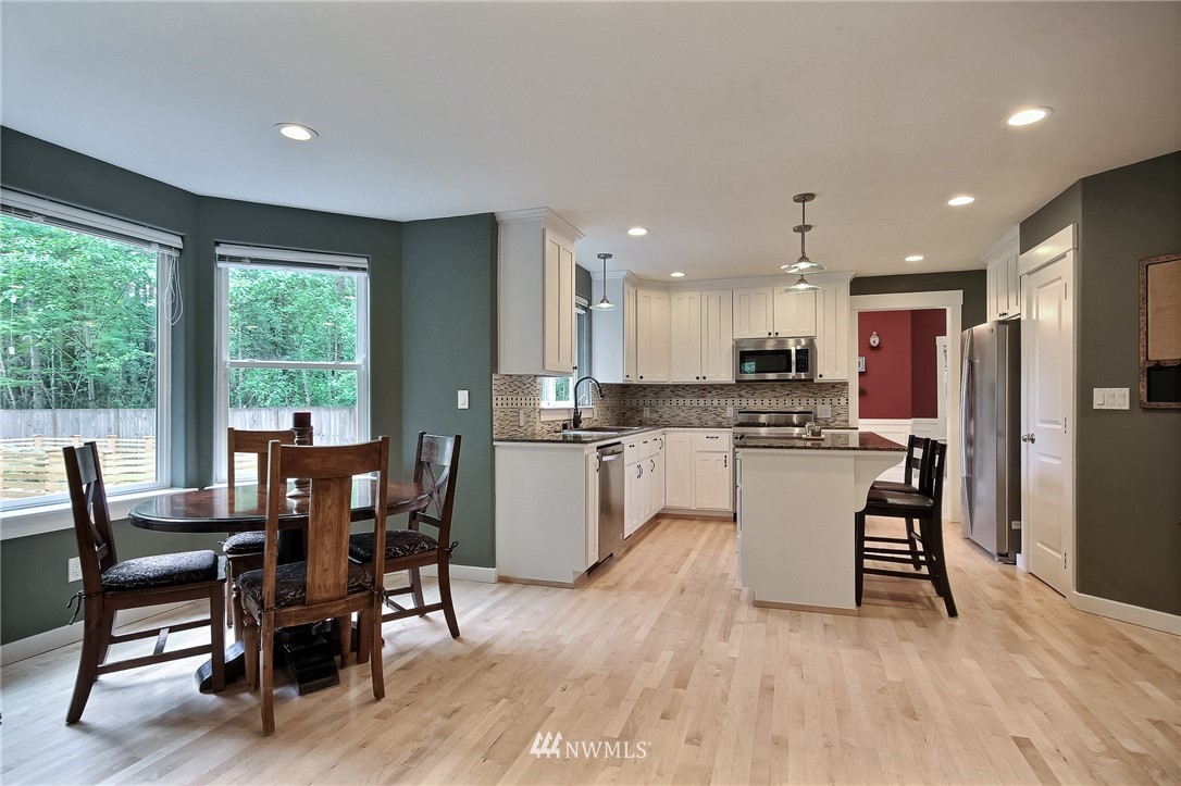4706 224th Street Southeast Bothell, WA 98021 - Photo 8 of 38 a view of a dining room with furniture window and wooden floor