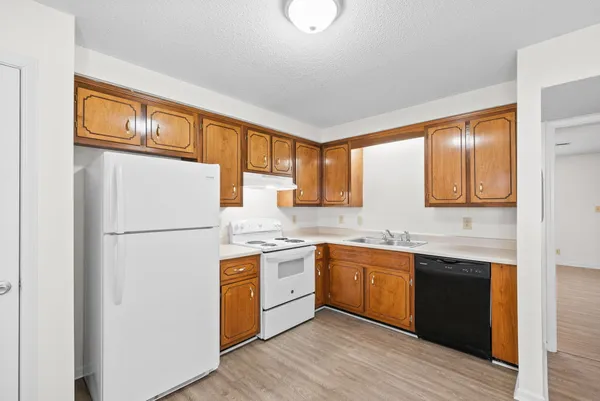 a kitchen with stainless steel appliances granite countertop a sink a stove and a microwave