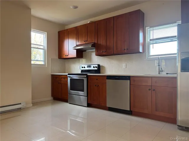 a kitchen with stainless steel appliances granite countertop a stove a sink dishwasher and a microwave oven