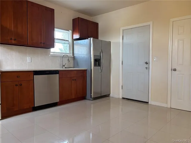 a kitchen with stainless steel appliances a refrigerator and cabinets