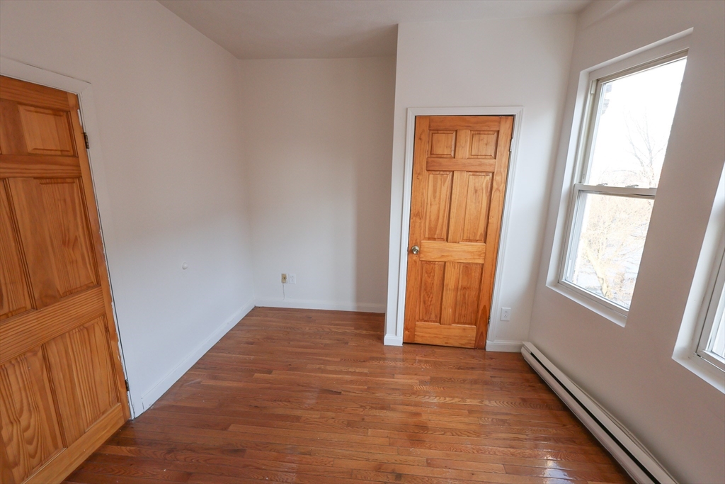1 Kenilworth Street, Unit 3 Boston, MA 02119 - Photo 8 of 10 an empty room with windows