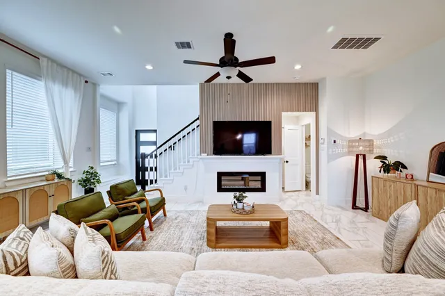 a living room with furniture and a fireplace