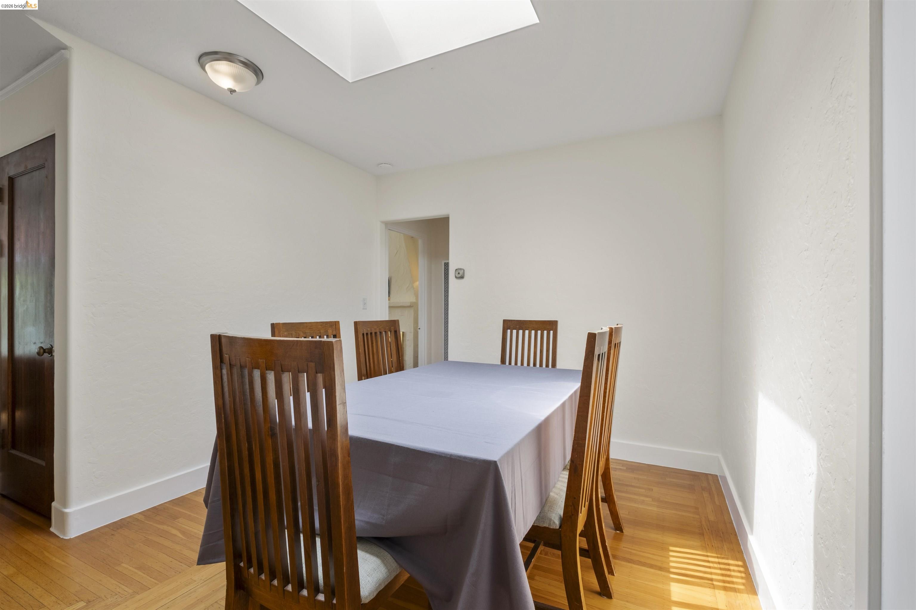 2444 Virginia Street, Unit B Berkeley, CA 94709 - Photo 20 of 39 Bright dining area featuring hardwood flooring, a recessed ceiling, a skylight, and a flush mount ceiling light