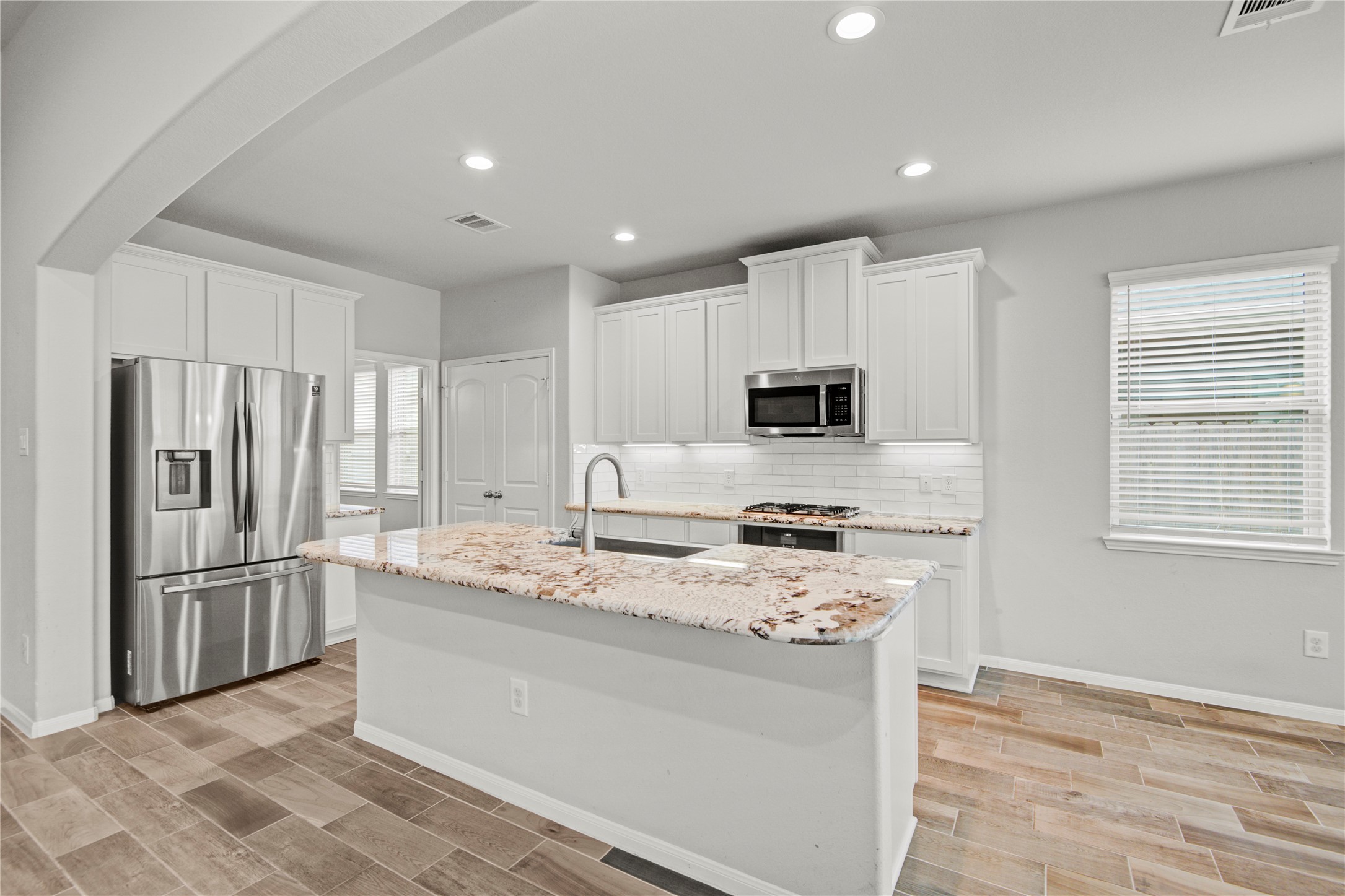 1314 Orchard Ridge Lane Tomball, TX 77375 - Photo 13 of 35 The kitchen is enhanced by a farmhouse sink, stainless steel appliances, and clean, modern finishes.