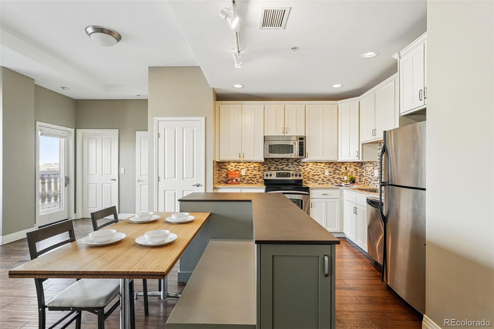 1950 Logan Street, Unit 1109 Denver, CO 80203 - Photo 12 of 49 a kitchen with refrigerator and wooden floor