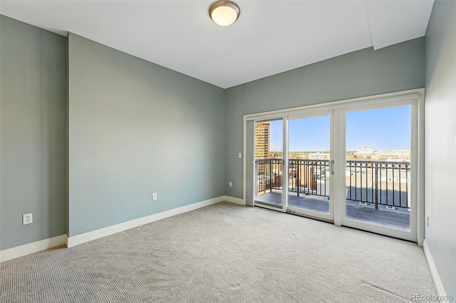 1950 Logan Street, Unit 1109 Denver, CO 80203 - Photo 15 of 49 a view of an empty room with glass door