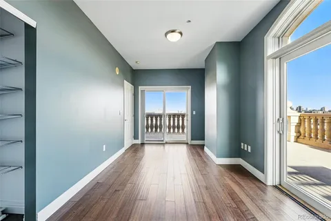 a view of a room with wooden floor
