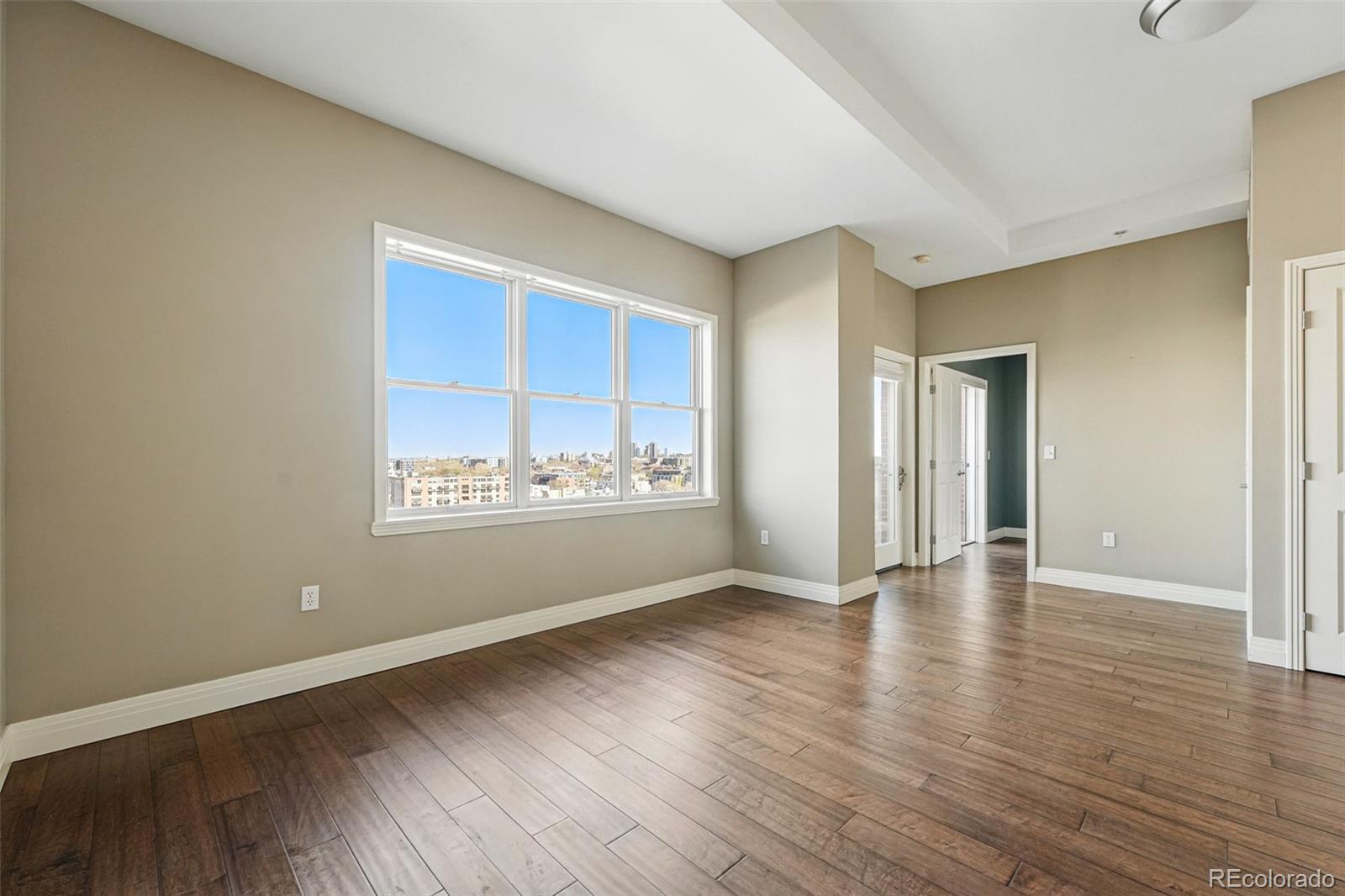 1950 Logan Street, Unit 1109 Denver, CO 80203 - Photo 28 of 49 a view of an empty room with wooden floor and a window