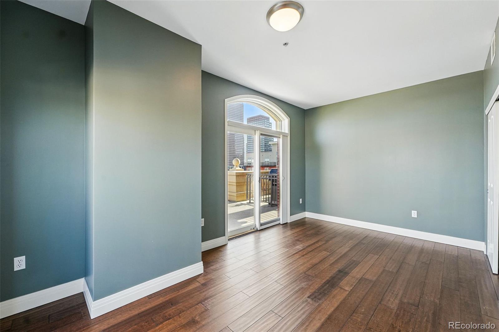 1950 Logan Street, Unit 1109 Denver, CO 80203 - Photo 31 of 49 a view of an empty room with wooden floor and a window