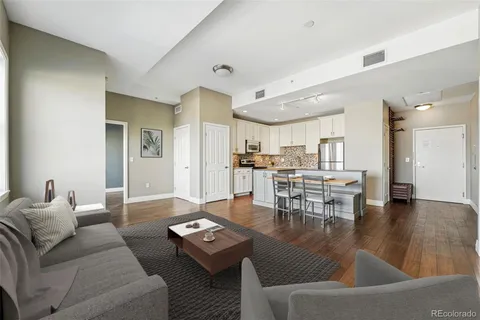 a living room with furniture kitchen and a table