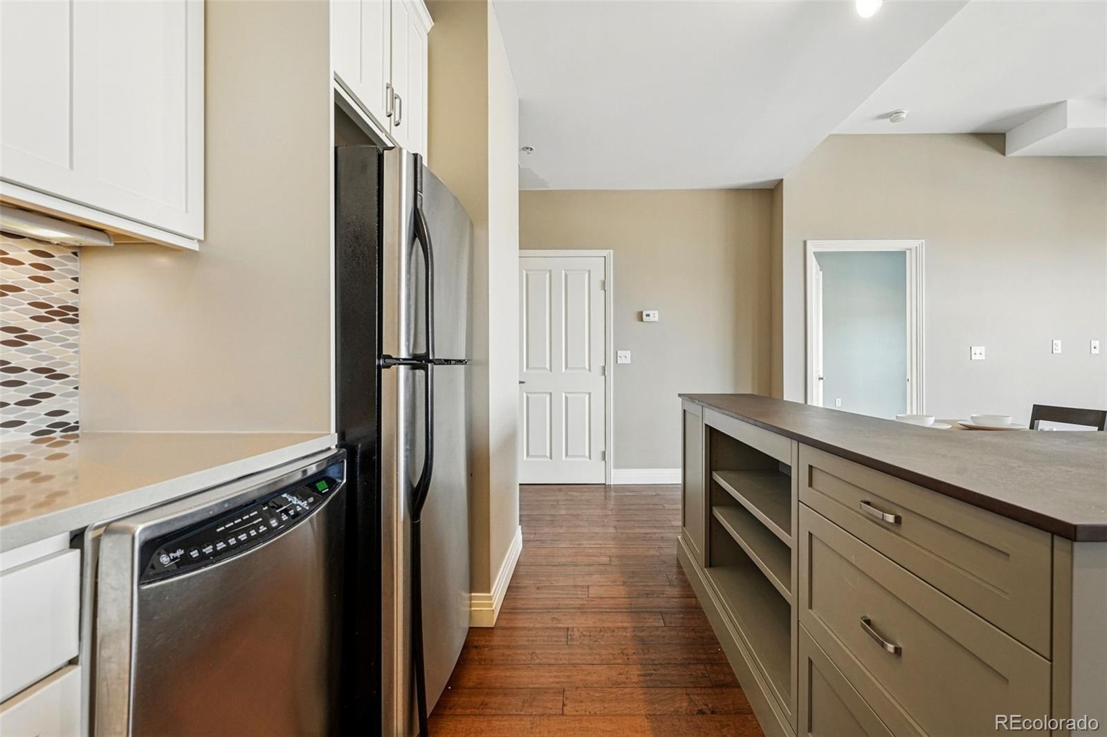 1950 Logan Street, Unit 1109 Denver, CO 80203 - Photo 7 of 49 a kitchen with granite countertop a refrigerator and a sink