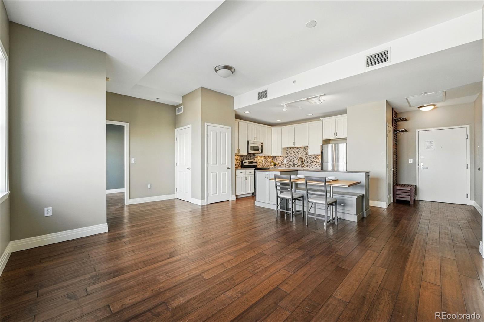 1950 Logan Street, Unit 1109 Denver, CO 80203 - Photo 10 of 49 a view of kitchen with furniture and wooden floor