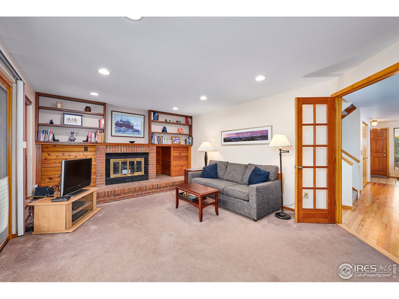2877 Tincup Circle Boulder, CO 80305 - Photo 13 of 38 a living room with furniture a flat screen tv and a fireplace