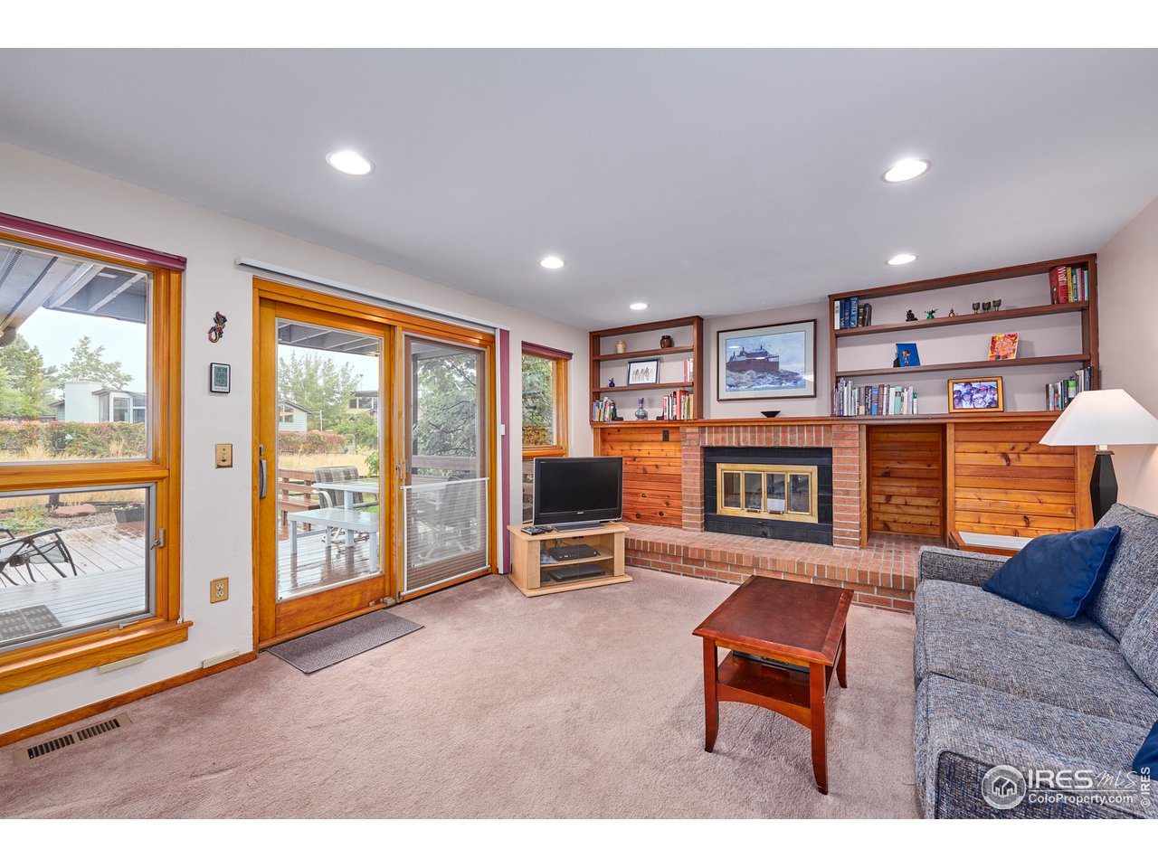 2877 Tincup Circle Boulder, CO 80305 - Photo 14 of 38 a living room with furniture a flat screen tv and a fireplace