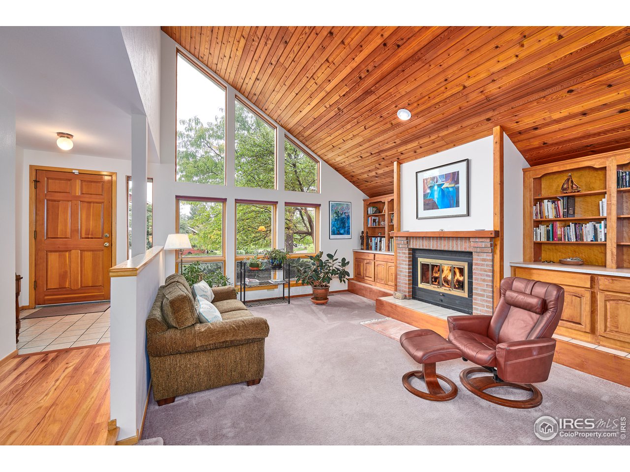 2877 Tincup Circle Boulder, CO 80305 - Photo 7 of 38 a living room with furniture a fireplace and floor to ceiling windows