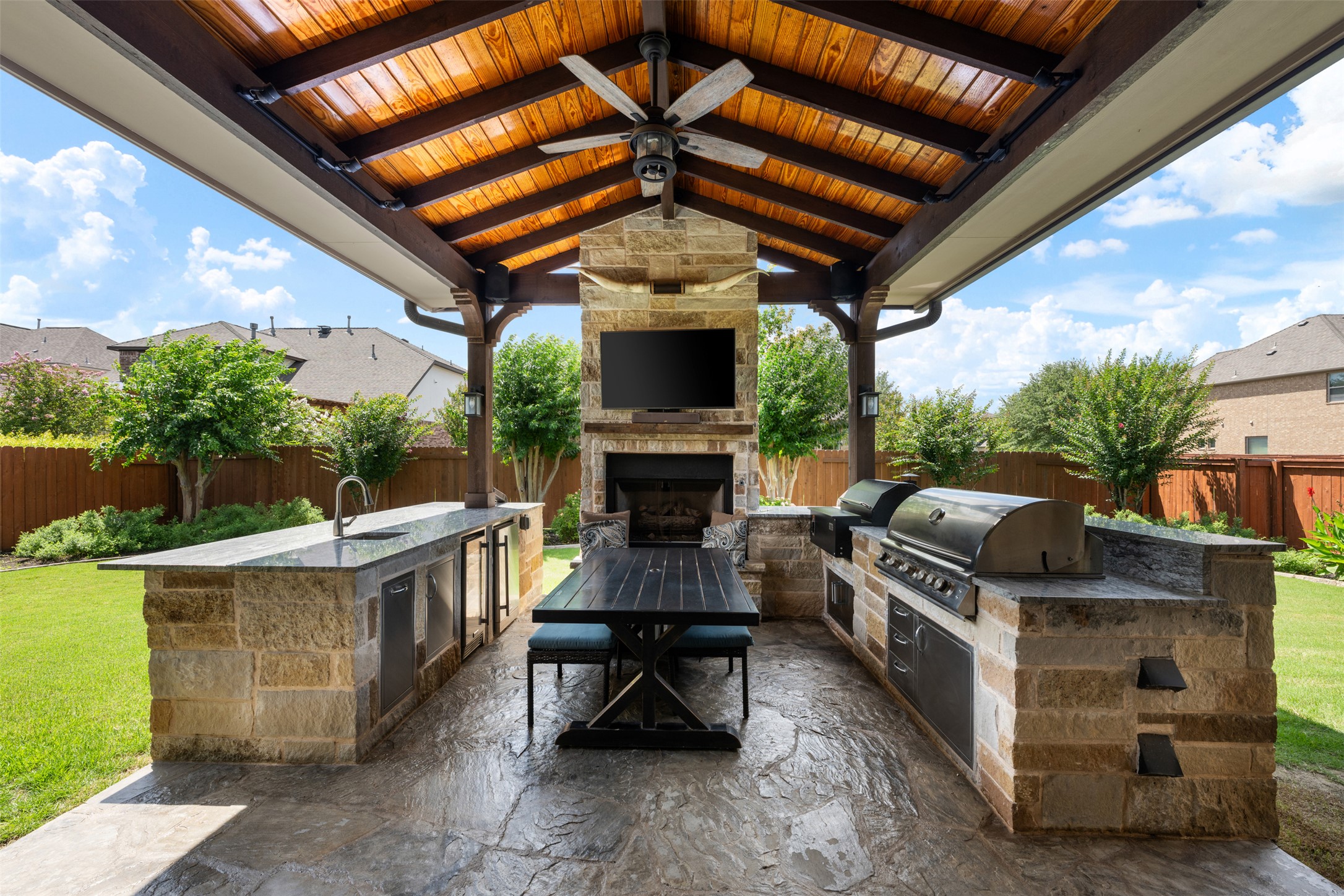3021 Wedgescale Pass Leander, TX 78641 - Photo 29 of 40 a patio with couches and a fireplace with the potted plants
