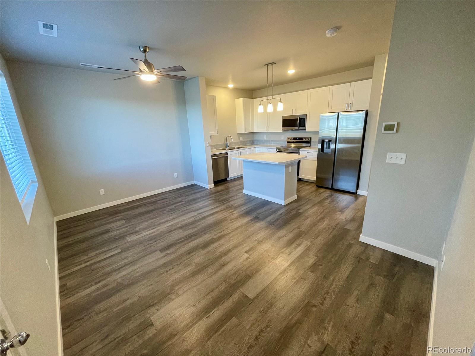 260 Pawnee Road, Unit C1 Ault, CO 80610 - Photo 2 of 14 a view of kitchen with wooden floor