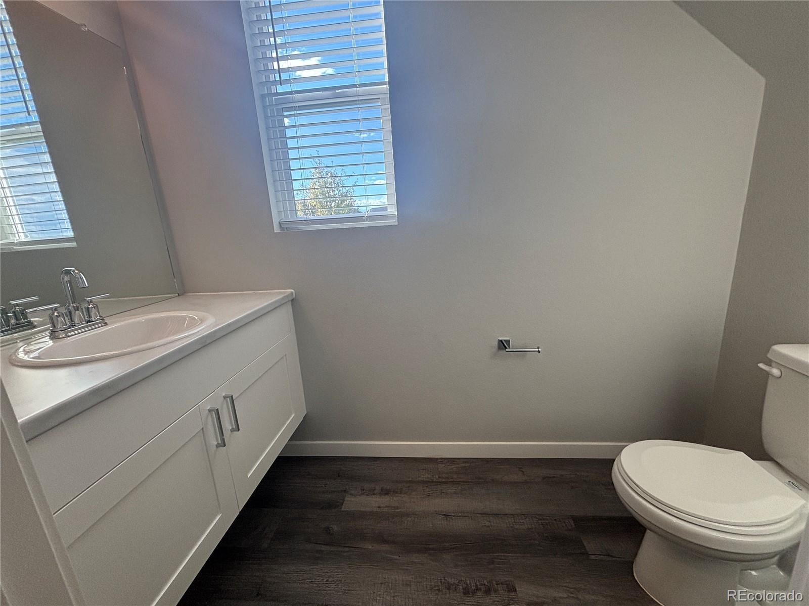 260 Pawnee Road, Unit C1 Ault, CO 80610 - Photo 4 of 14 a bathroom with a sink a toilet and vanity