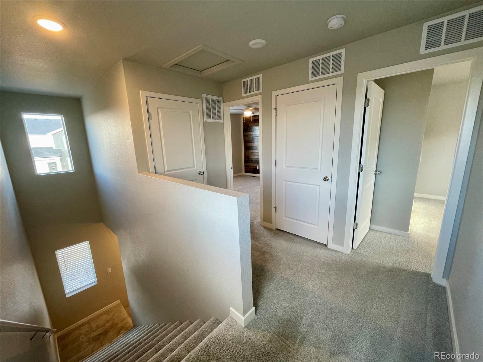 260 Pawnee Road, Unit C1 Ault, CO 80610 - Photo 6 of 14 a view of an empty room with wooden floor and a mirror