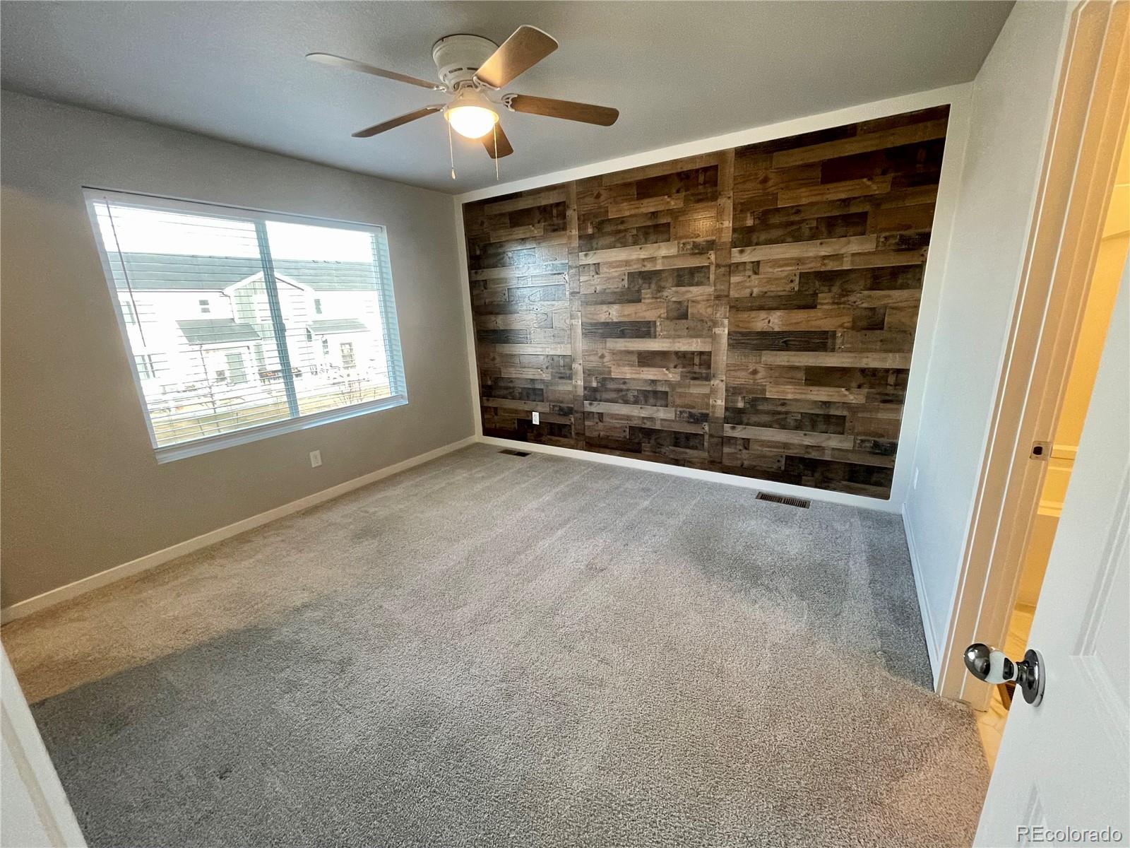 260 Pawnee Road, Unit C1 Ault, CO 80610 - Photo 8 of 14 an empty room with windows and fan