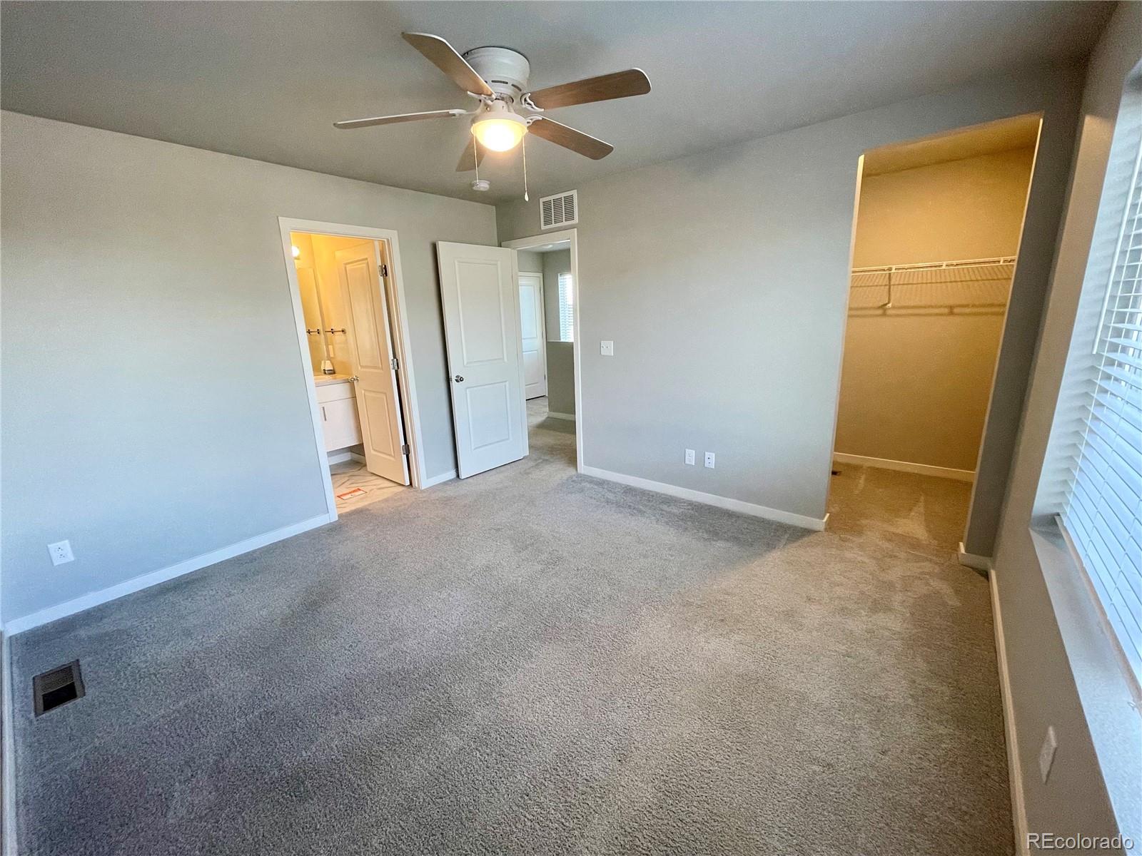 260 Pawnee Road, Unit C1 Ault, CO 80610 - Photo 9 of 14 an empty room with windows and fan