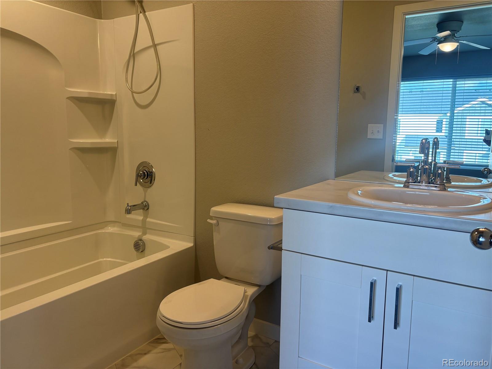 260 Pawnee Road, Unit C1 Ault, CO 80610 - Photo 10 of 14 a bathroom with a sink a toilet and shower