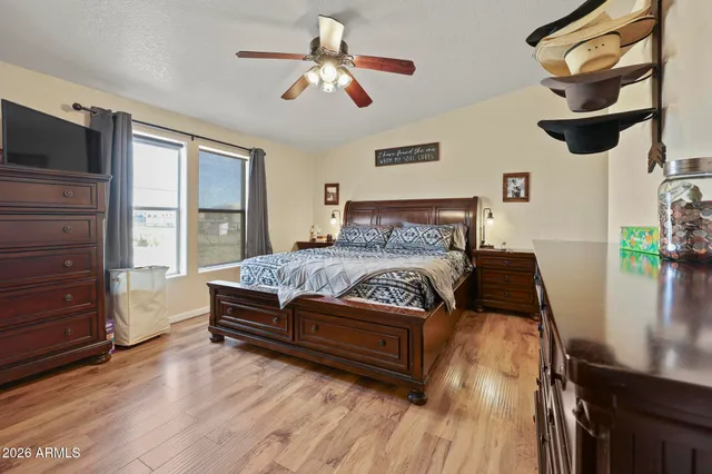 a bedroom with a bed dresser and a window