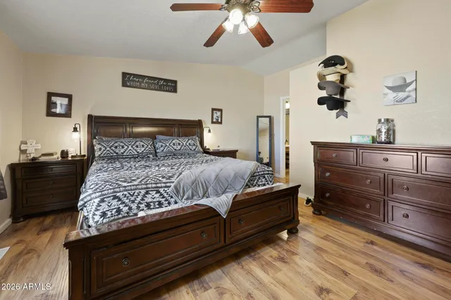 a bedroom with a bed and wooden floor