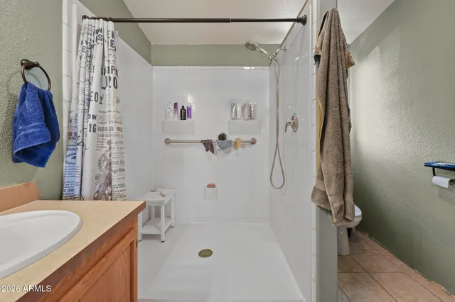a bathroom with a tub shower sink and vanity
